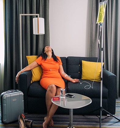 Relaxing in a hotel room during a jet lag recovery IV drip
